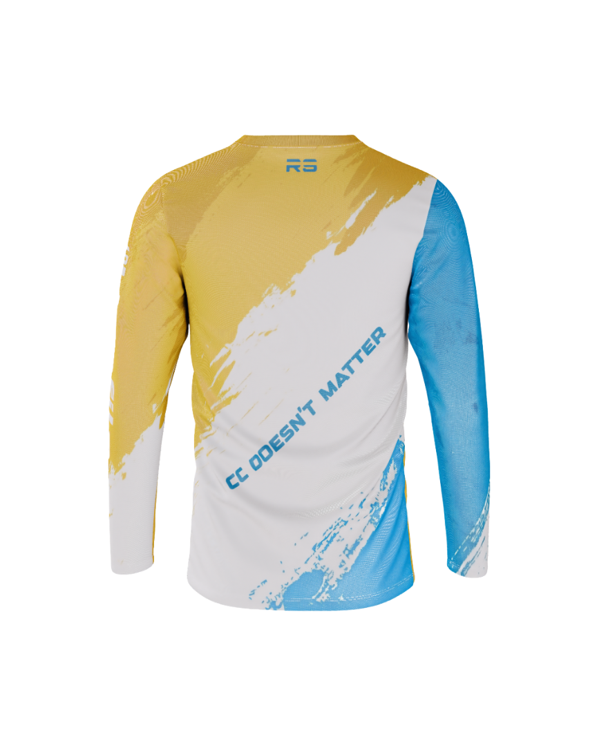 A long-sleeve athletic jersey shown from the back, featuring a yellow-to-white diagonal brushstroke design on the upper back and shoulders, a white center, a blue lower section, and a blue right sleeve. The text 'CC DOESN'T MATTER' is printed diagonally across the back in blue, and a small blue 'RS' logo is visible at the collar.